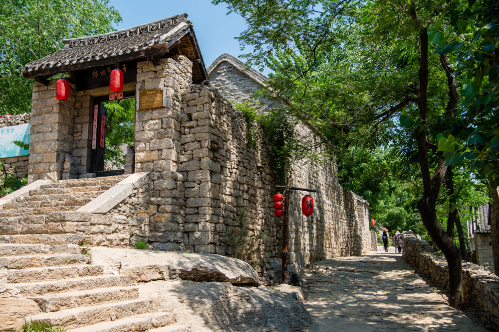 姓来此定居,因周围崇山峻岭,且为区别其后山的又一村,取名"上九山村"